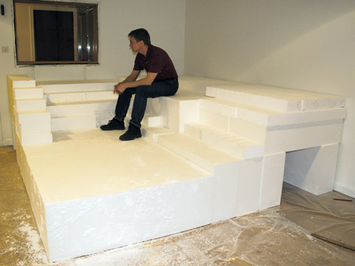 The author sits upon plastic foam blocks used to configure the enclosure’s shape.