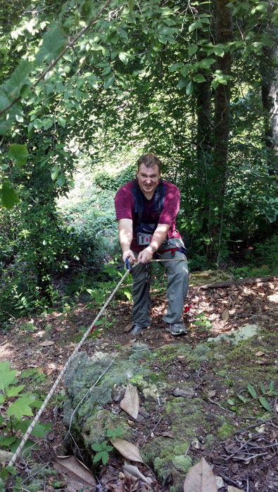 Mike Wines rappels down a steep cliff to find the red hills salamander